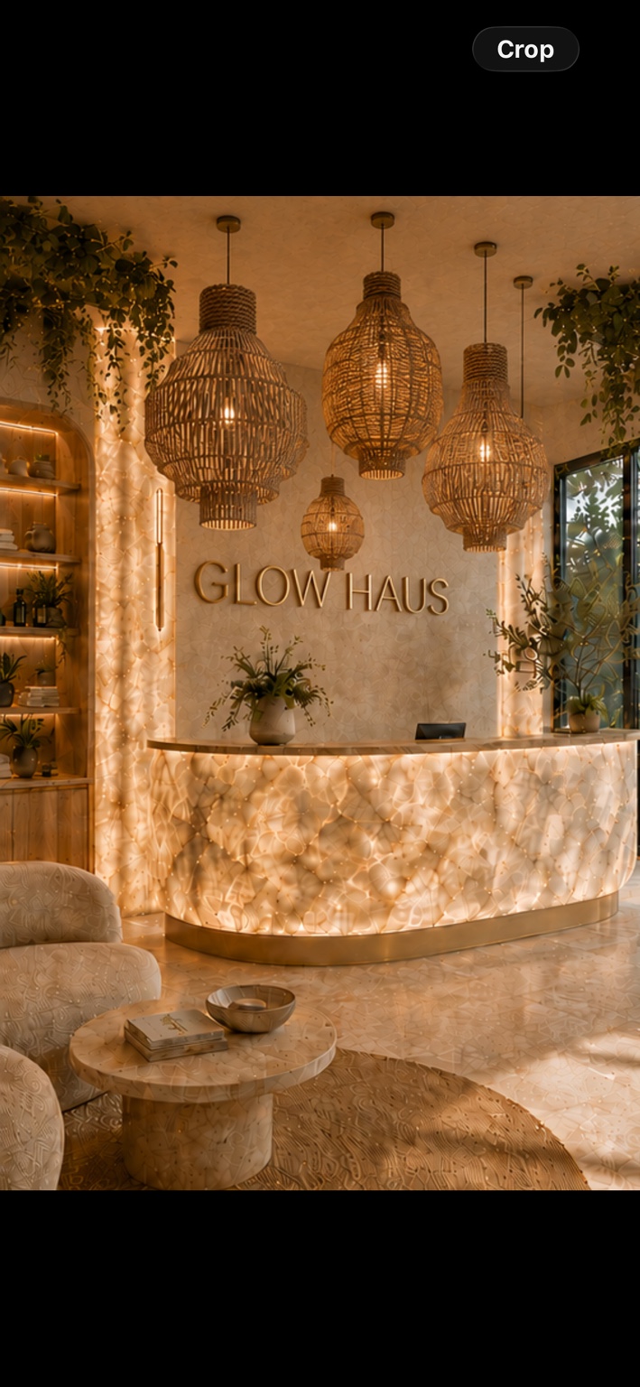 Glow Haus reception with an illuminated marble desk, oversized woven pendant lights and ceiling greenery